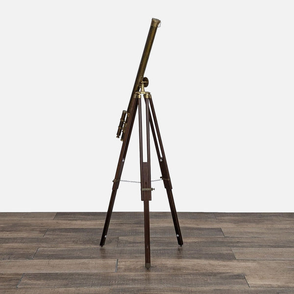 Vintage brass telescope on a wooden tripod, adjustable height.