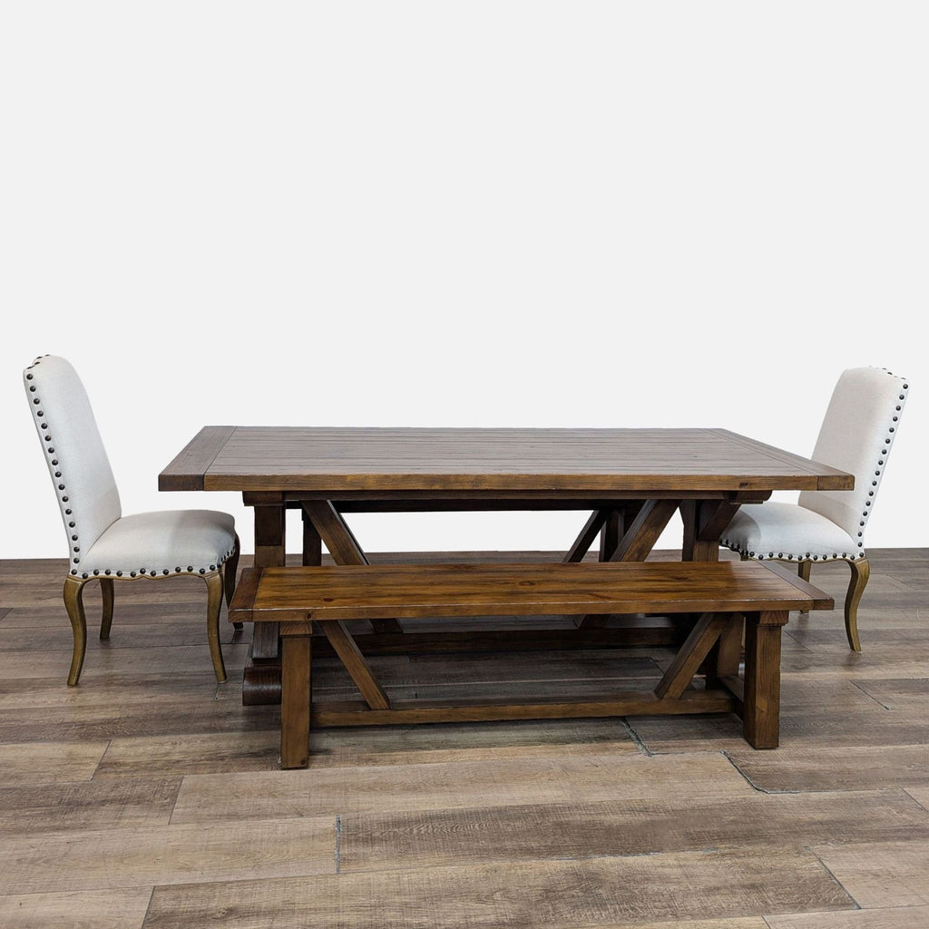 Rustic farmhouse dining set with table, two benches, and upholstered chairs.