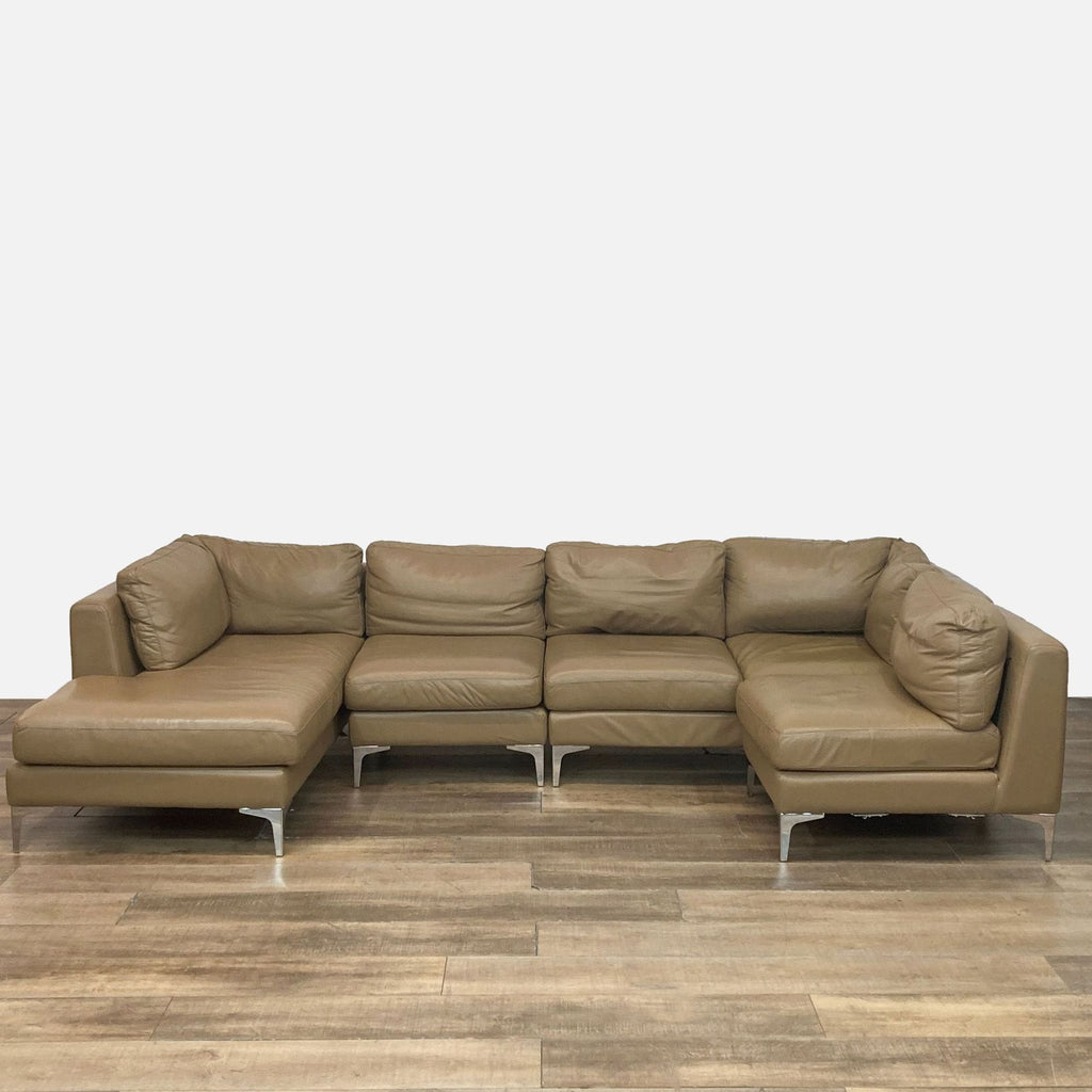 Modular U-shaped sectional sofa in light brown leather with metal legs.