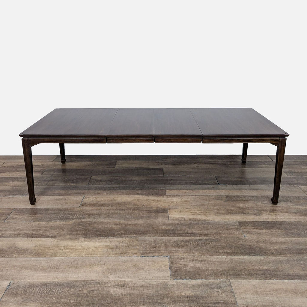 Expansive wood dining table by Reperch featuring three leaf inserts on wooden flooring background.