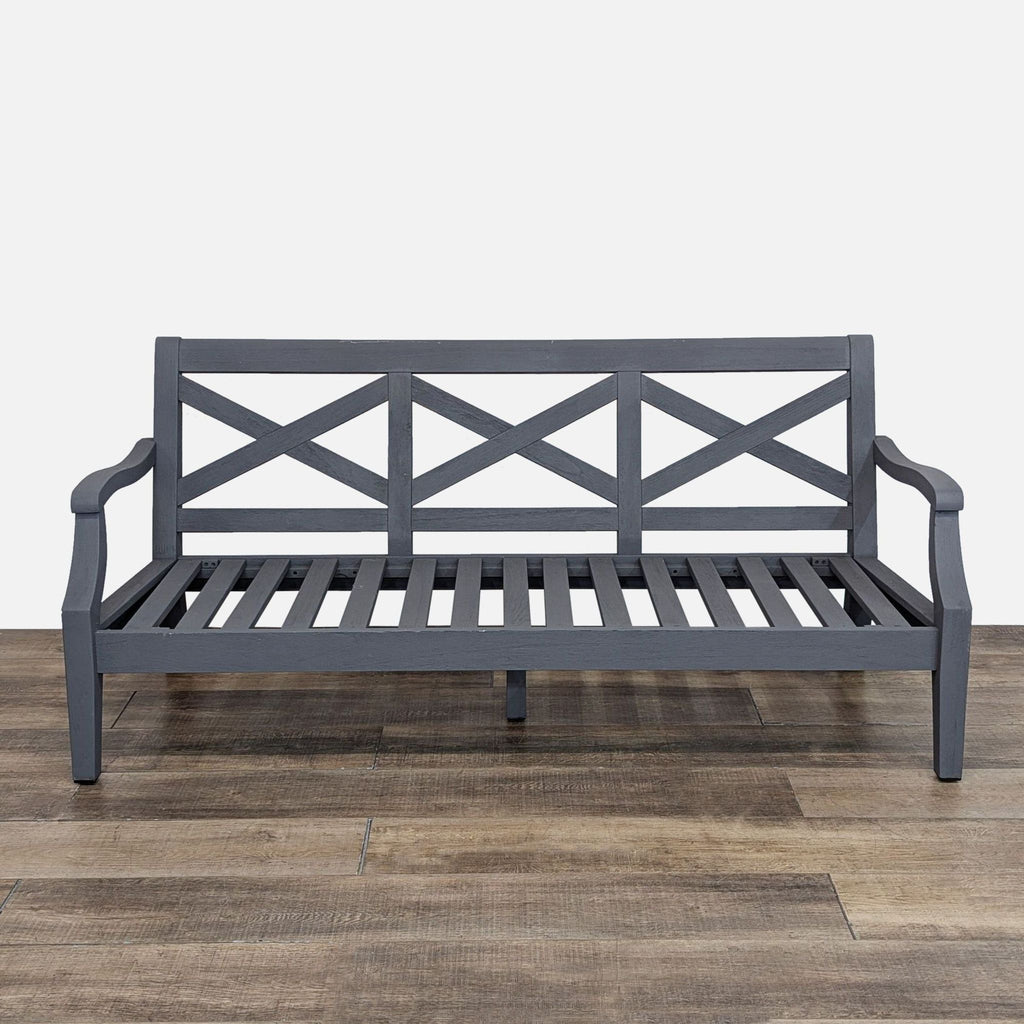 Front view of a gray wooden bench with a crisscross back design.  