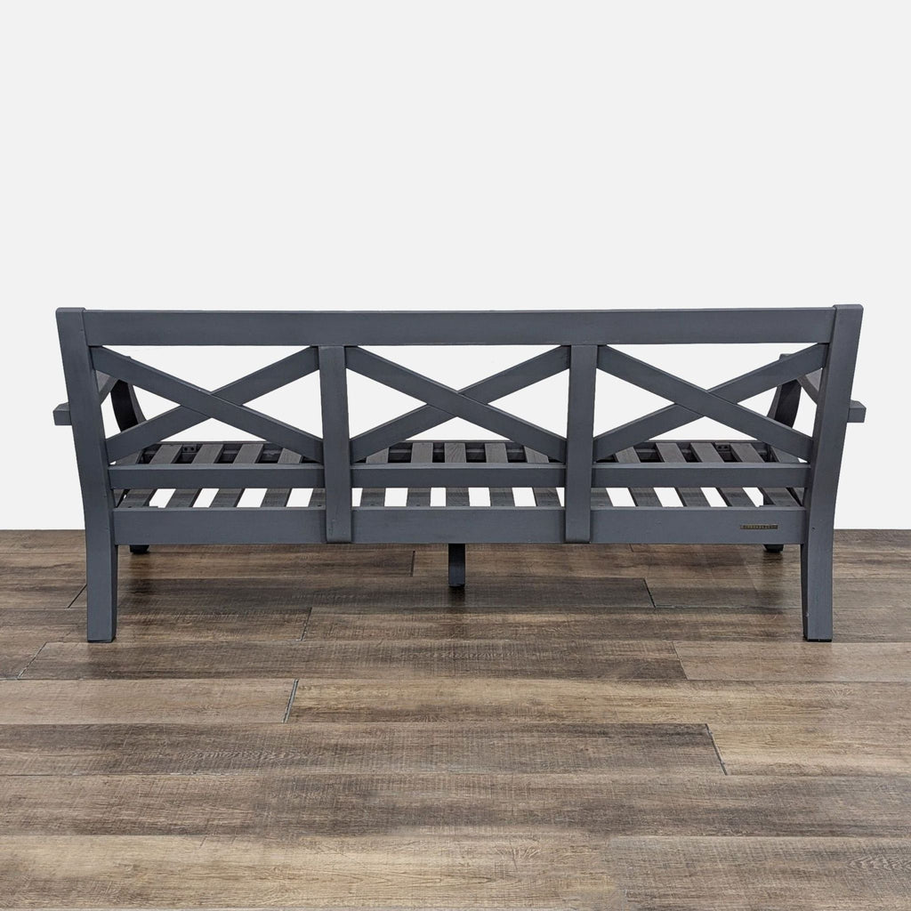Back view of a gray bench featuring a crisscross back pattern.