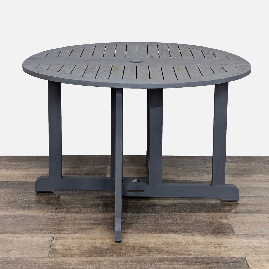 Pottery Barn set with drop leaf table and criss cross chairs for outdoor dining enjoyment.