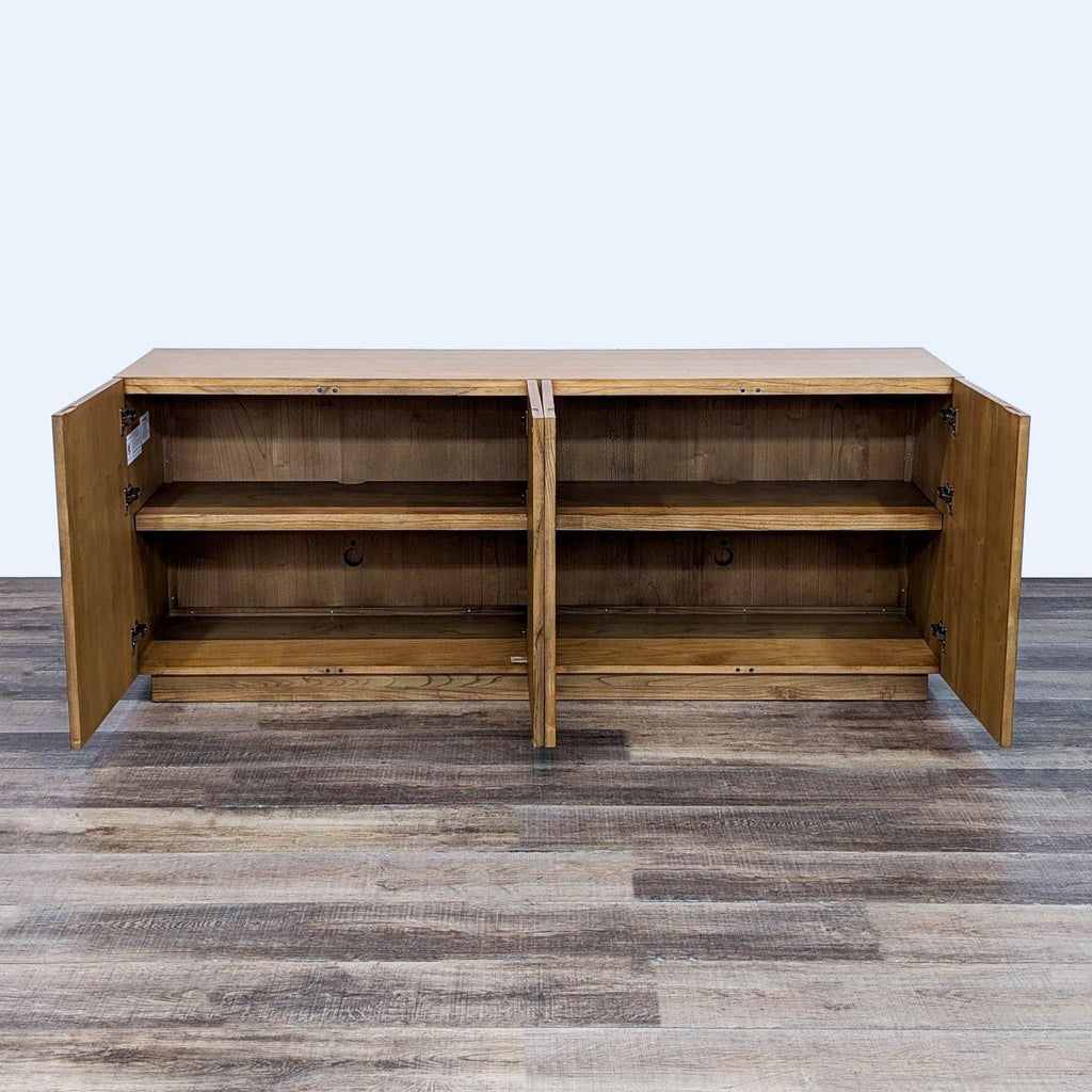 Interior view of a wooden sideboard with open doors.