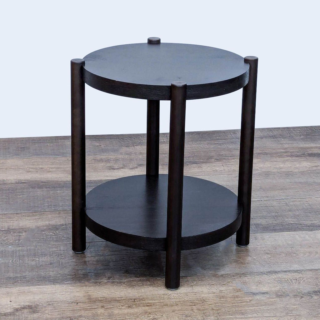 Dark round table with two shelves, suitable for side or console use, from Ikea.
