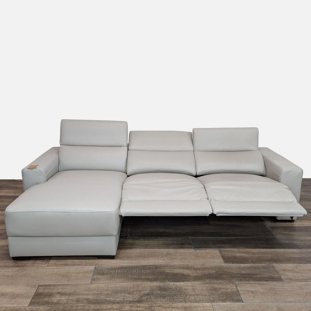 Sectional sofa by Reperch in leather, featuring a chaise lounge and two reclining seats.