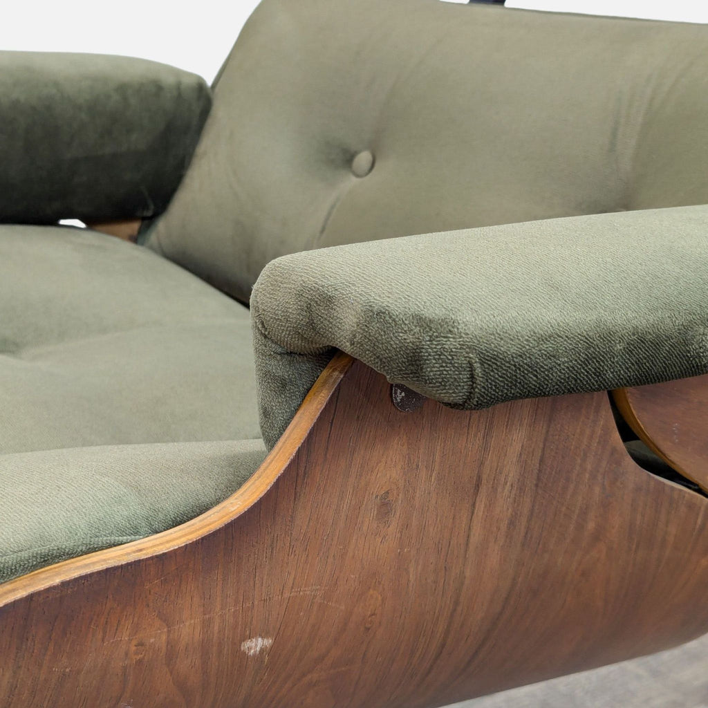 Close-up of dark green velvet upholstery and bentwood frame detail on Reperch Eames chair.