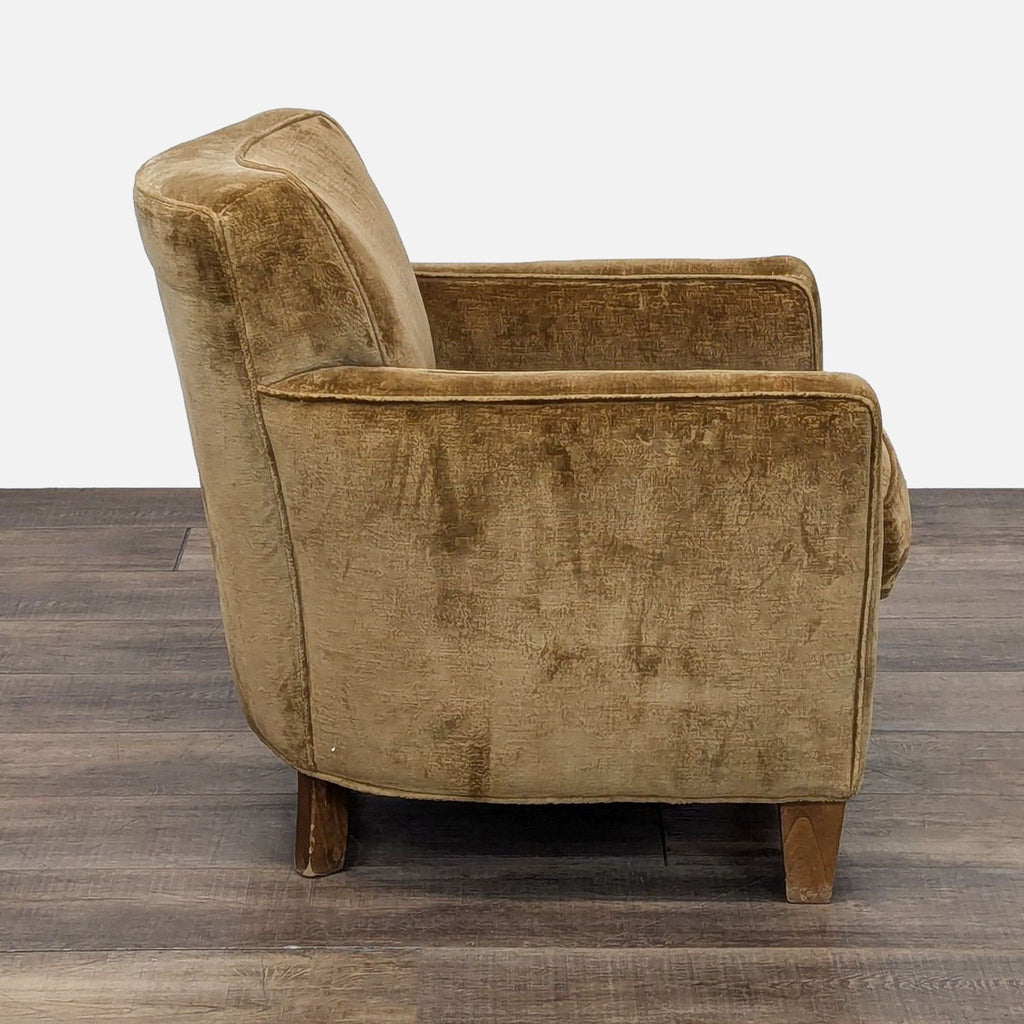 Side view of chenille-upholstered lounge chair by Fisher Weisman with wooden legs.