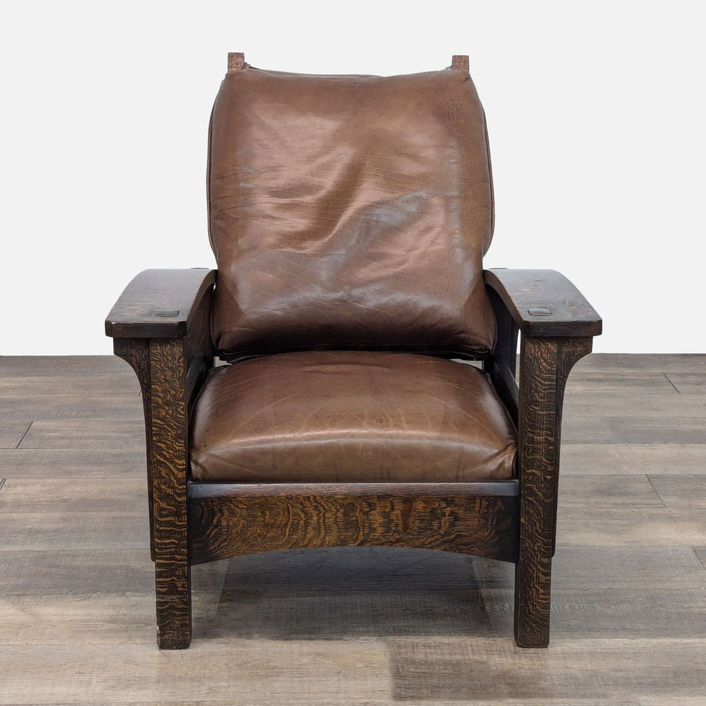 Front view of a Warren Hile Studio oak lounge chair with leather cushion.