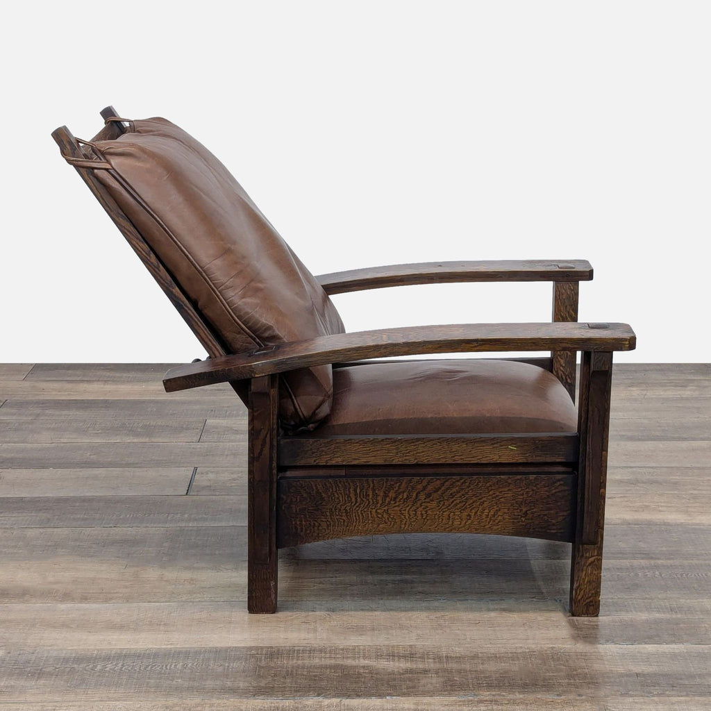 Side profile of a Warren Hile Studio lounge chair, oak frame and leather cushion.