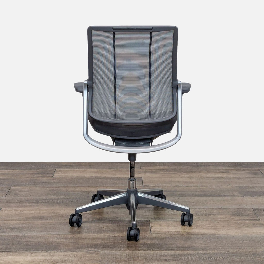 Back view of a HumanScale office chair with monofilament stripe and mechanism-free recline.