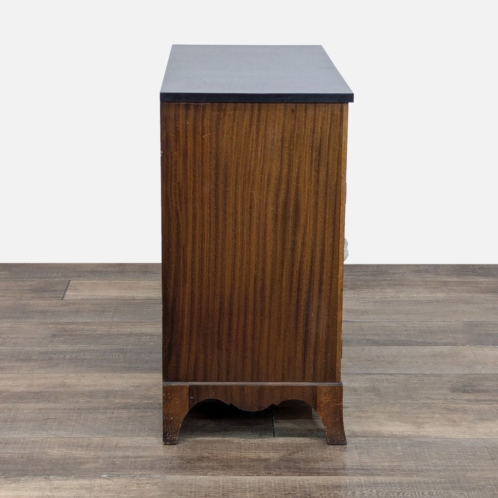 Wooden side view of a Reperch credenza with decorative base.