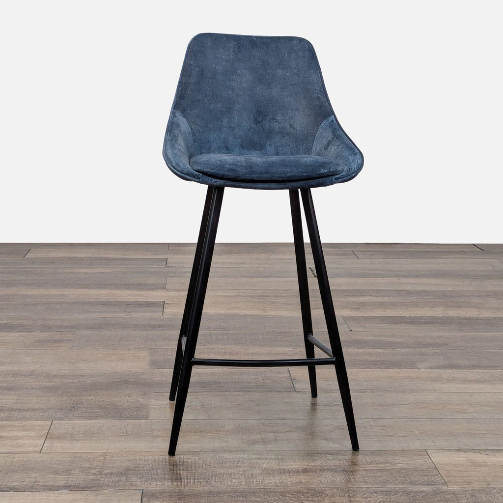 Reperch stool with blue seat, black metal legs, wood floor.