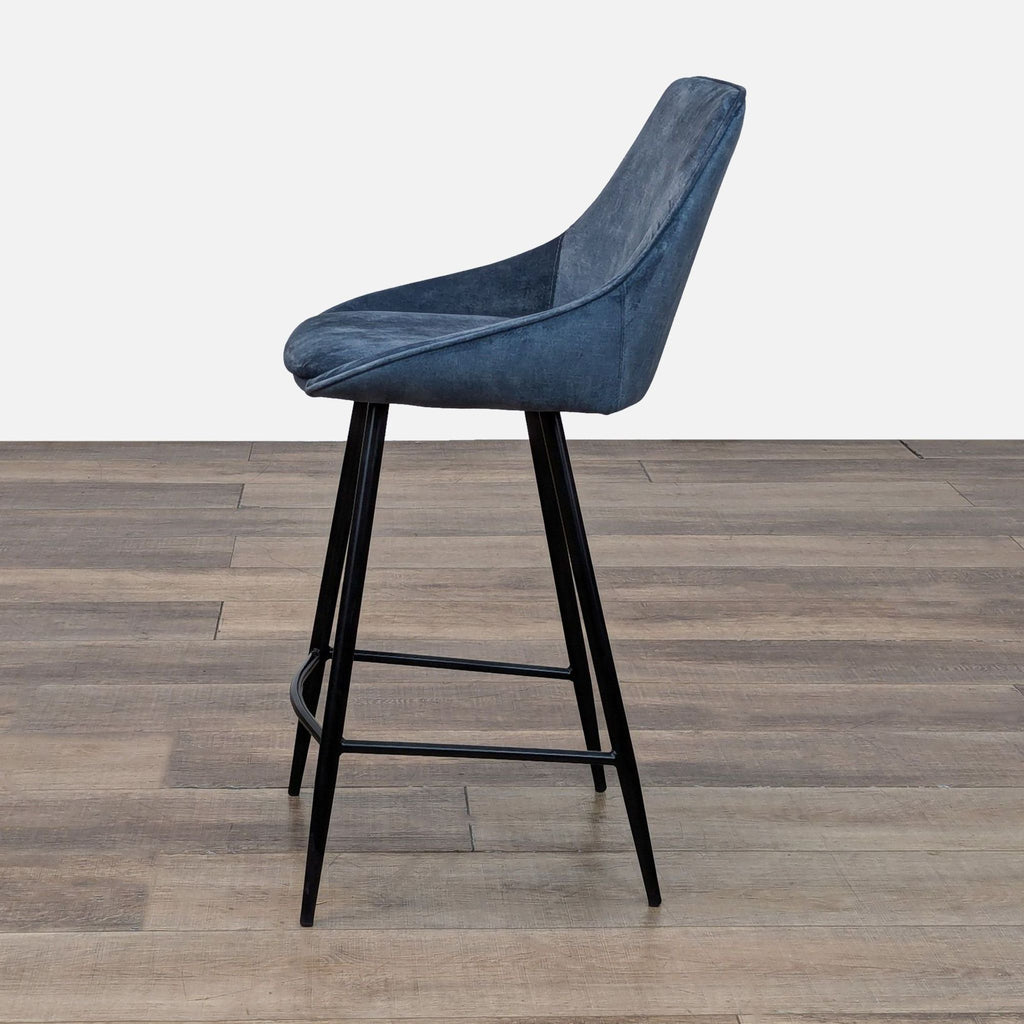 Side view of Reperch stool, blue seat, sleek design.