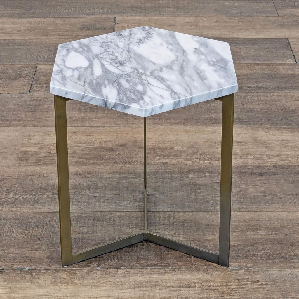 Top view of hexagonal marble side table with brushed metal base.