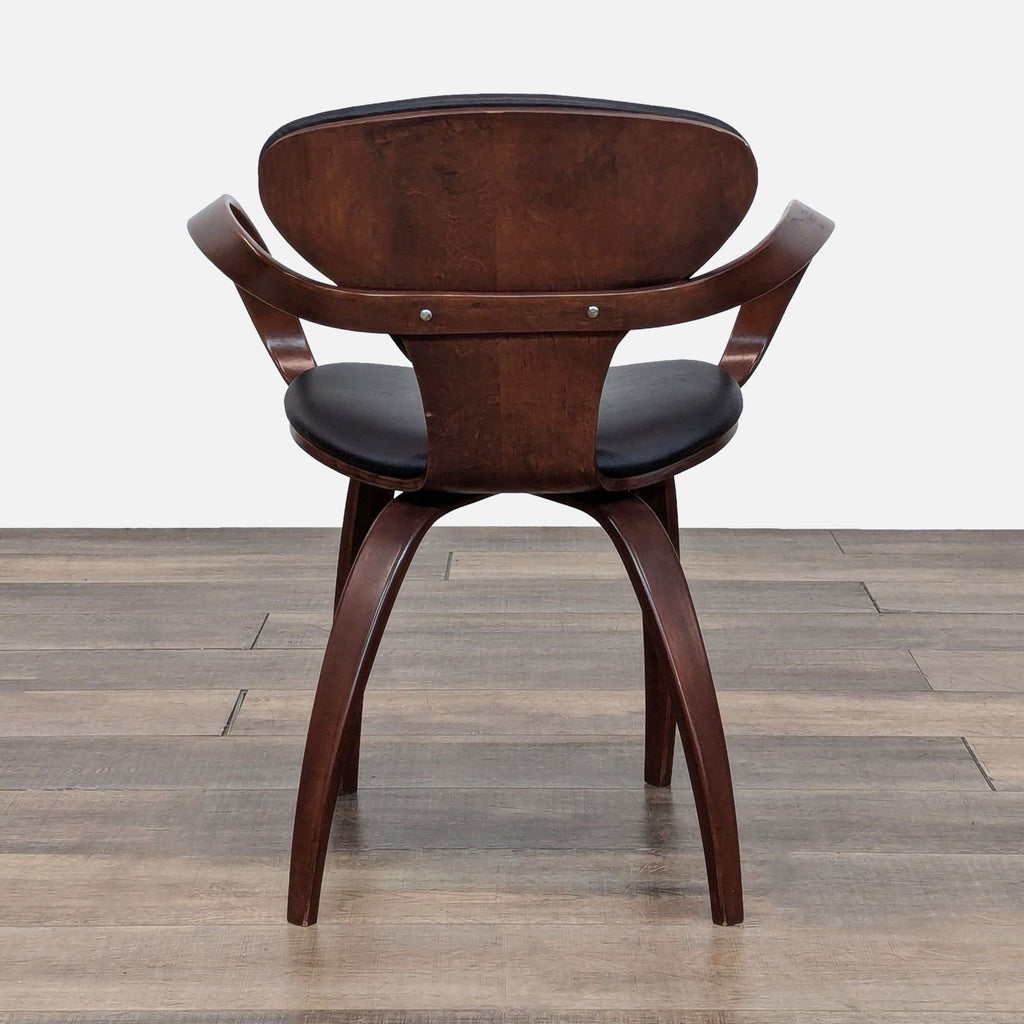 Rear view of a Cherner dining chair, highlighting the bentwood backrest and curved arms. Classic mid-century style.