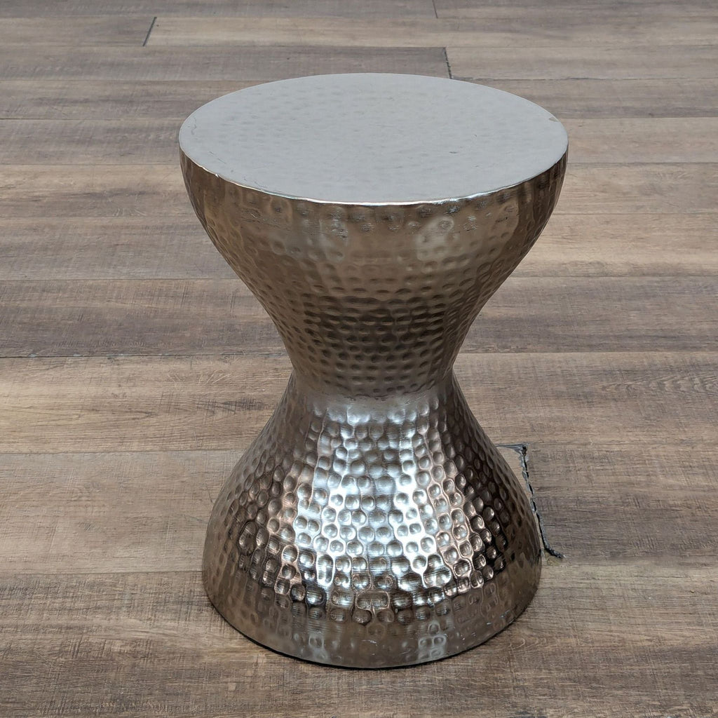 Dakota Fields metal side table with a unique, hammered finish on flooring.
