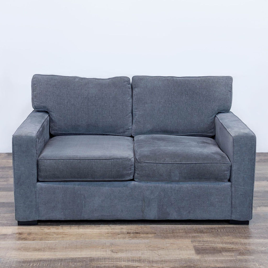 Gray loveseat with textured upholstery and mocha-finished legs, viewed from the front.