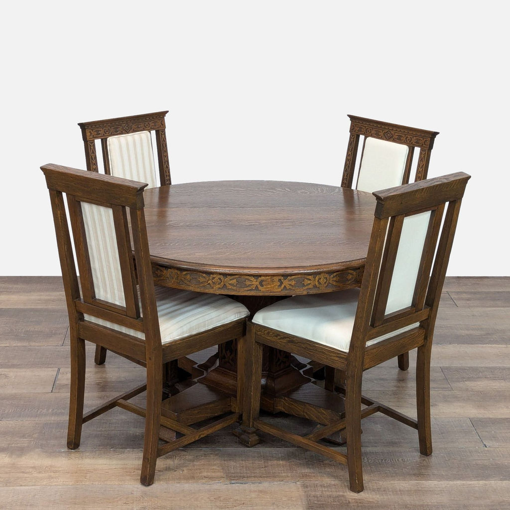 Round oak dining set with carved detailing and cream upholstered chairs. Includes two expansion leafs.