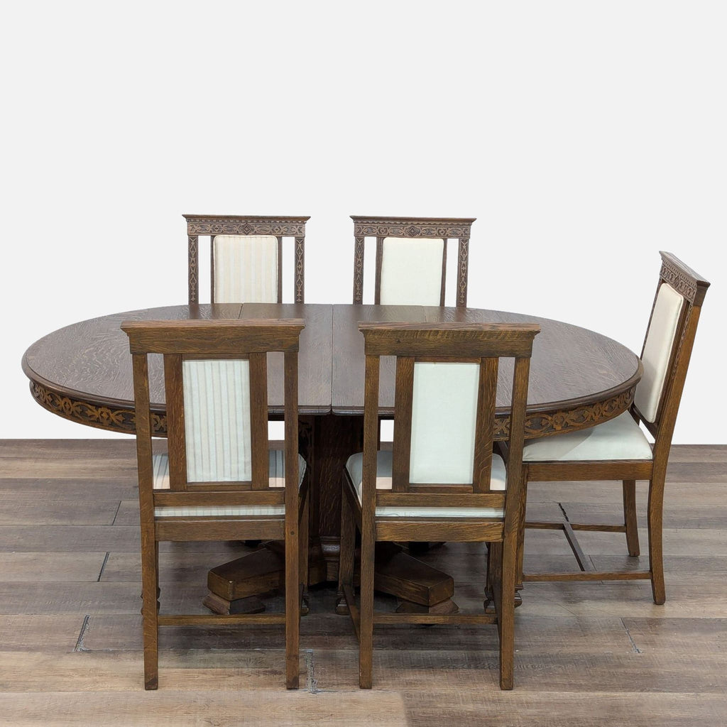 Dining set featuring a round oak table with expansion leafs and cream upholstered chairs with oak frames.