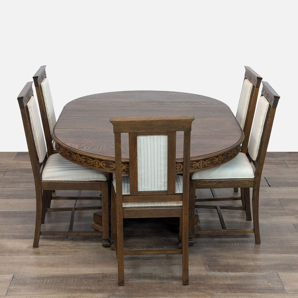 Elegant dining set by Reperch with a round oak table and four upholstered chairs, featuring intricate carvings.