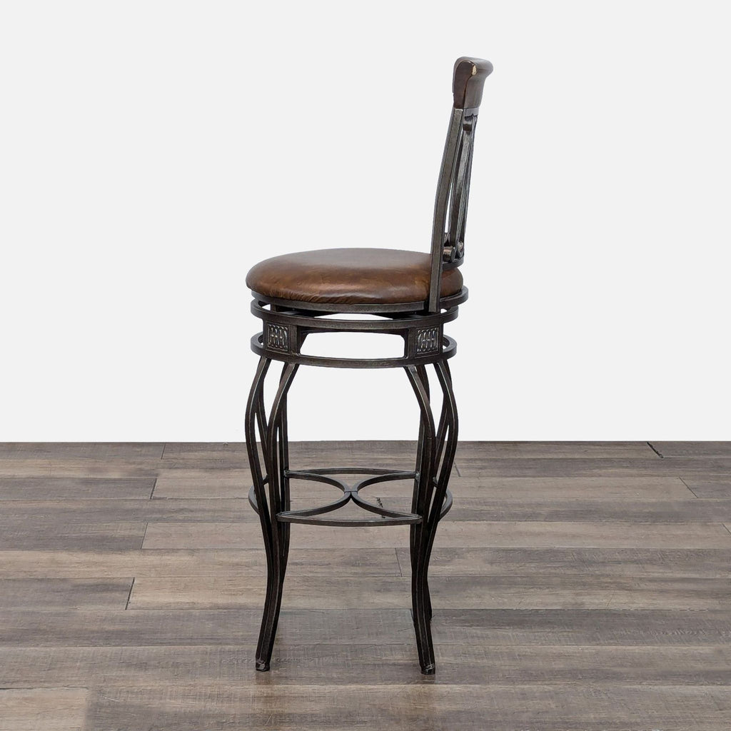 Side profile of a Reperch stool, highlighting its elegant metal design and round, cushioned seat.