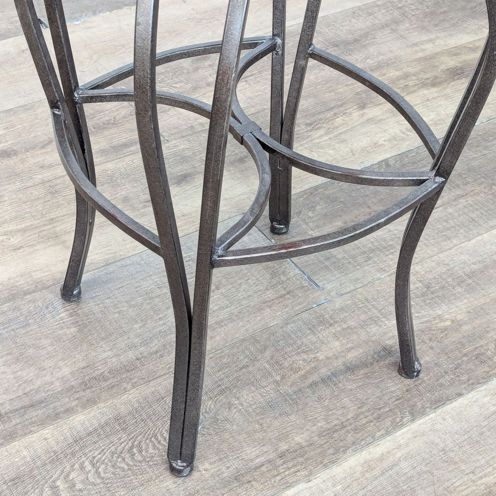 Close-up of Reperch stool's metal frame, showcasing intricate detailing and sturdy leg structure.