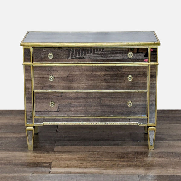 Baroque dresser with mirrored panels and antique gold trim.