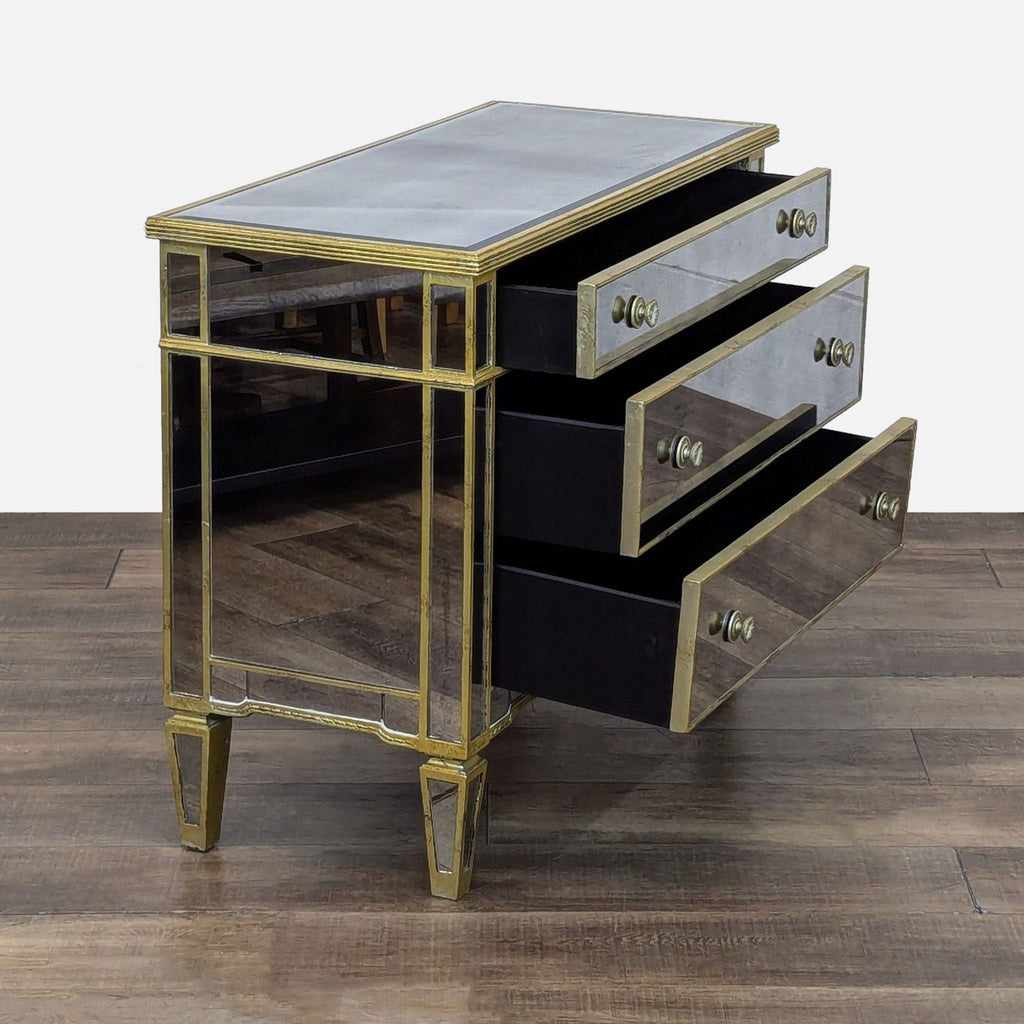 Side view of mirrored dresser, showing gold-trimmed details.