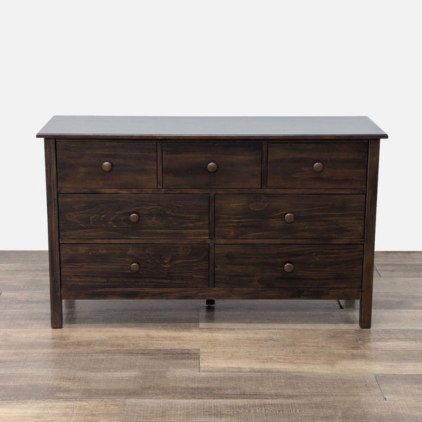 Kendall Dresser with wood veneer finish and 7 drawers featuring wooden knobs.