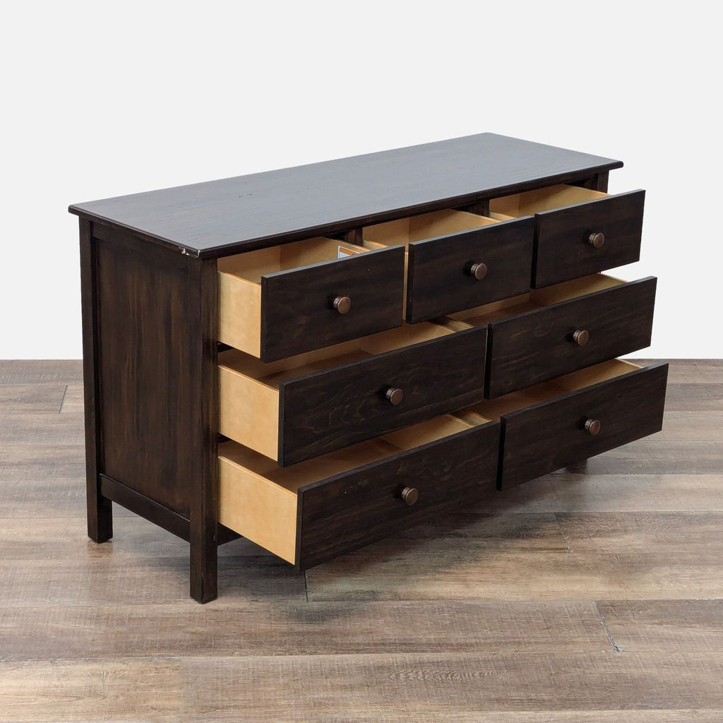 Side view of the Kendall Dresser with open wood glide drawers and matching knobs.
