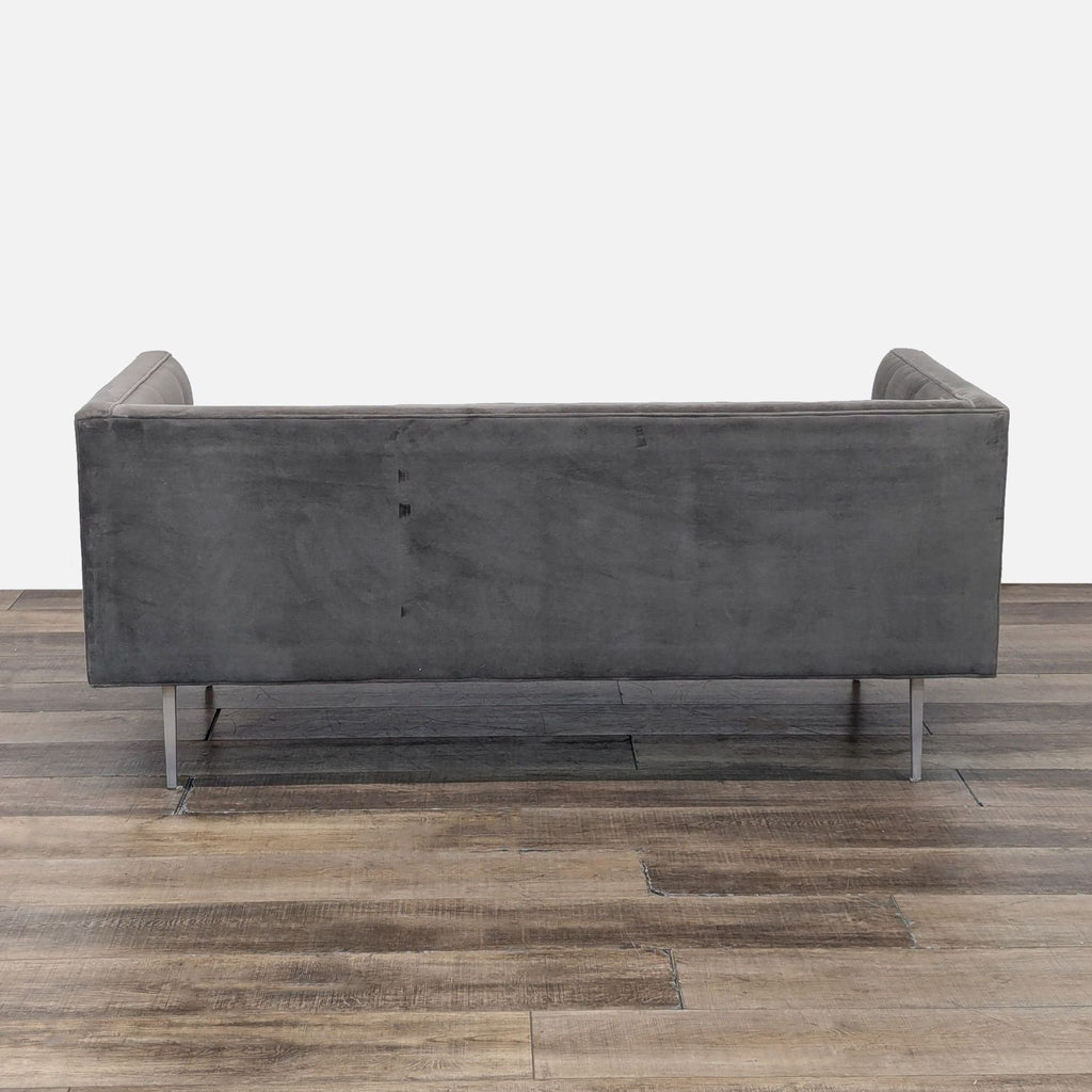 Back view of gray 3-seat Reperch sofa, showcasing metal legs and smooth suede upholstery.