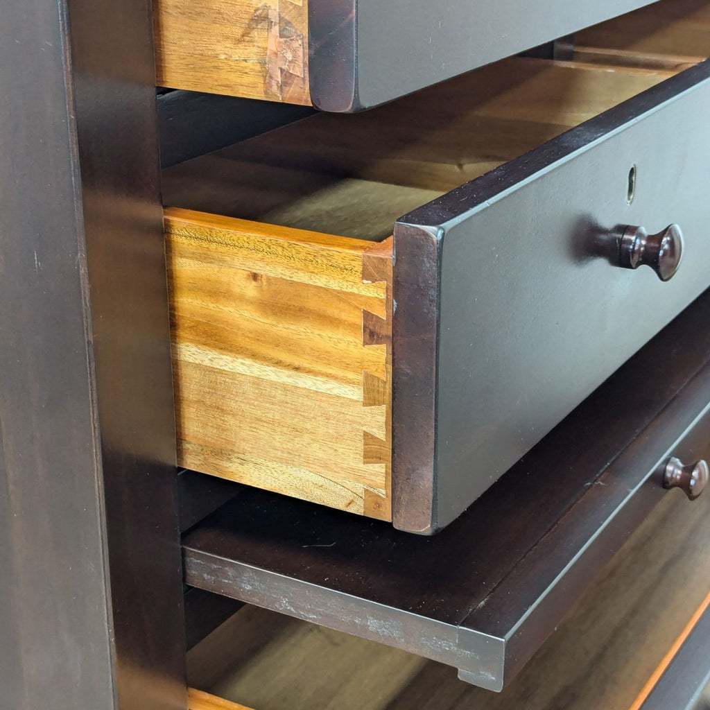 Close-up of drawer detail with dovetail joints, illustrating craftsmanship and wood texture.