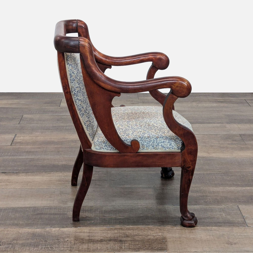 Elegant lounge chair by Reperch, showcasing a carved wood frame and floral fabric design.