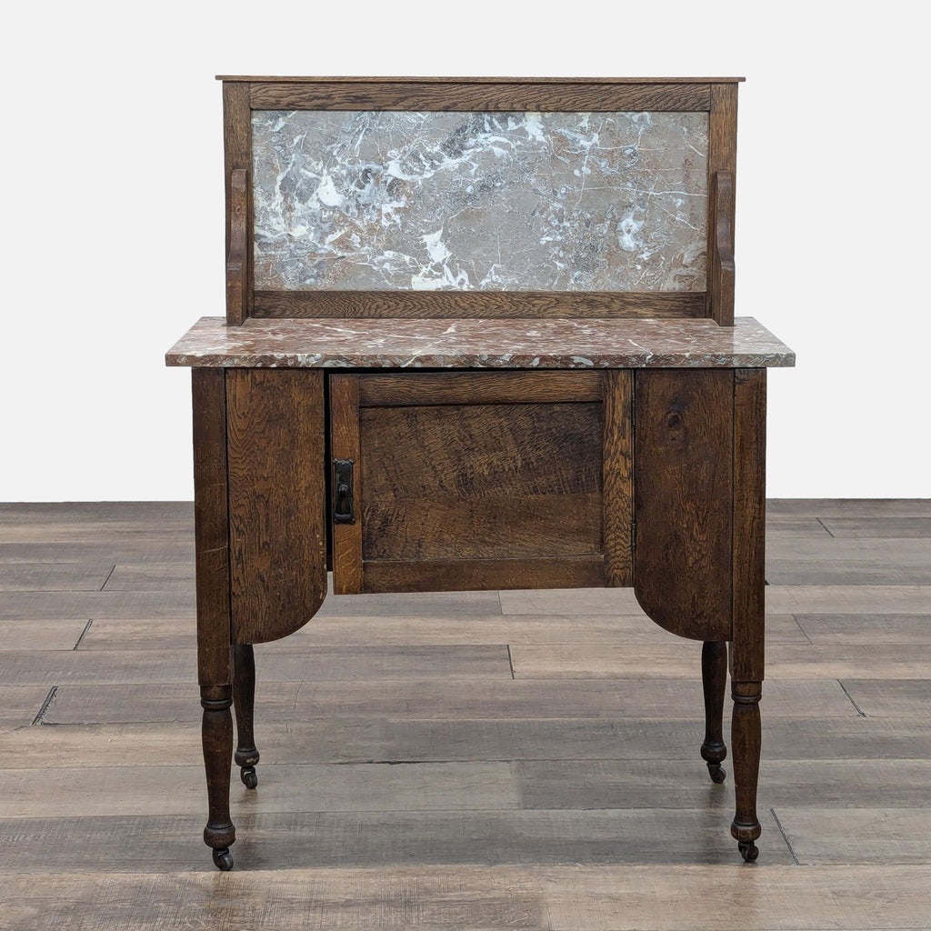 Antique 20th-century washstand with oak, walnut finish, marble top, and turned legs. Front view.