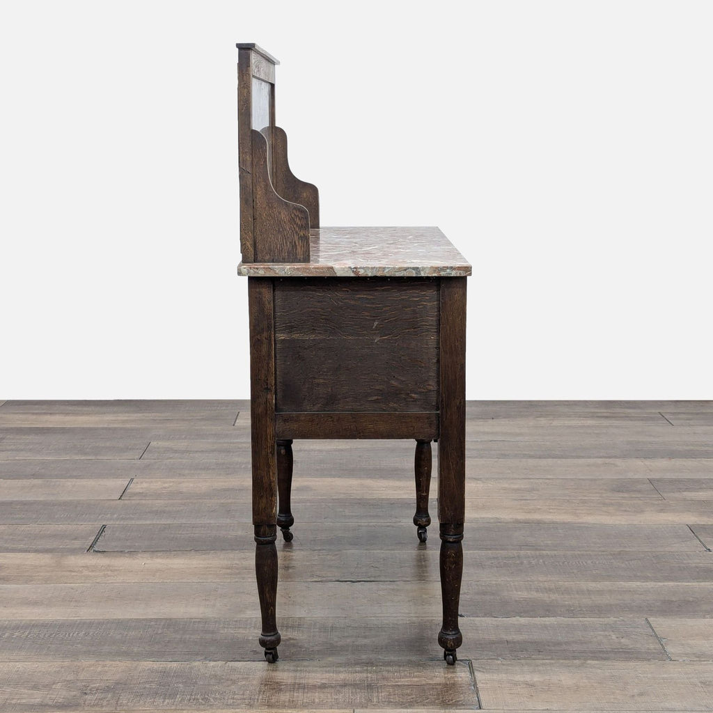 Antique washstand side view displaying oak, walnut finish, and marble top with decorative turned legs.