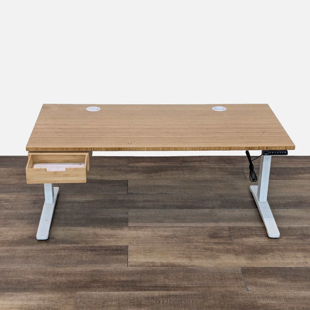 Adjustable Uplift desk with a bamboo surface, white base, drawer, USB ports, and a programmable keypad.