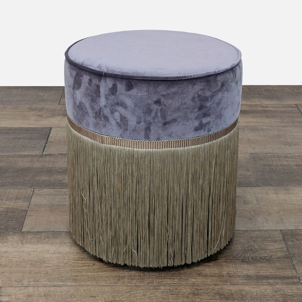 Circular velvet ottoman with tassel trim and beech wood legs, crafted in Italy.