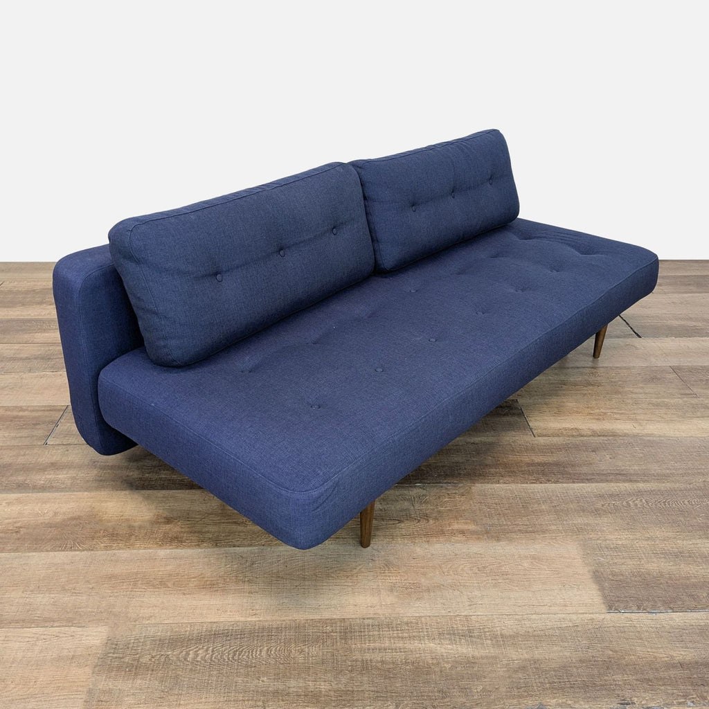 Room & Board Deco sofa side view, fabric with button tufting.