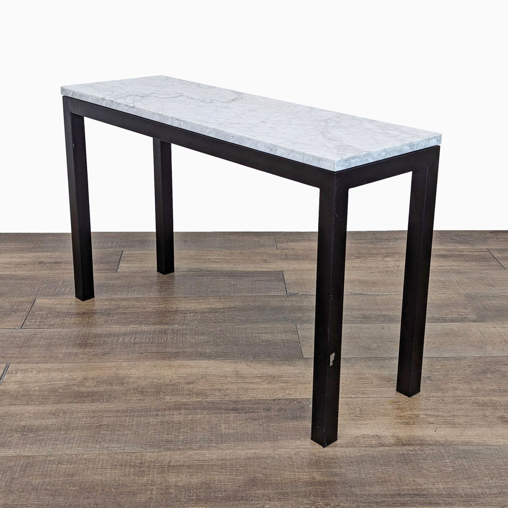 Side view of a Crate & Barrel console table with marble surface and steel frame.