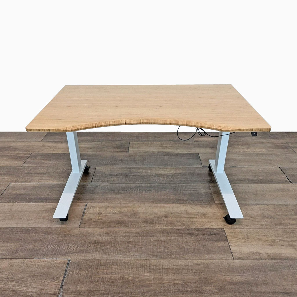 Reperch desk featuring a bamboo surface and adjustable white metal legs.