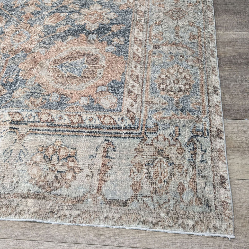 2. Close-up of Persian-style rug pattern in ocean blue, tan, and rust hues.