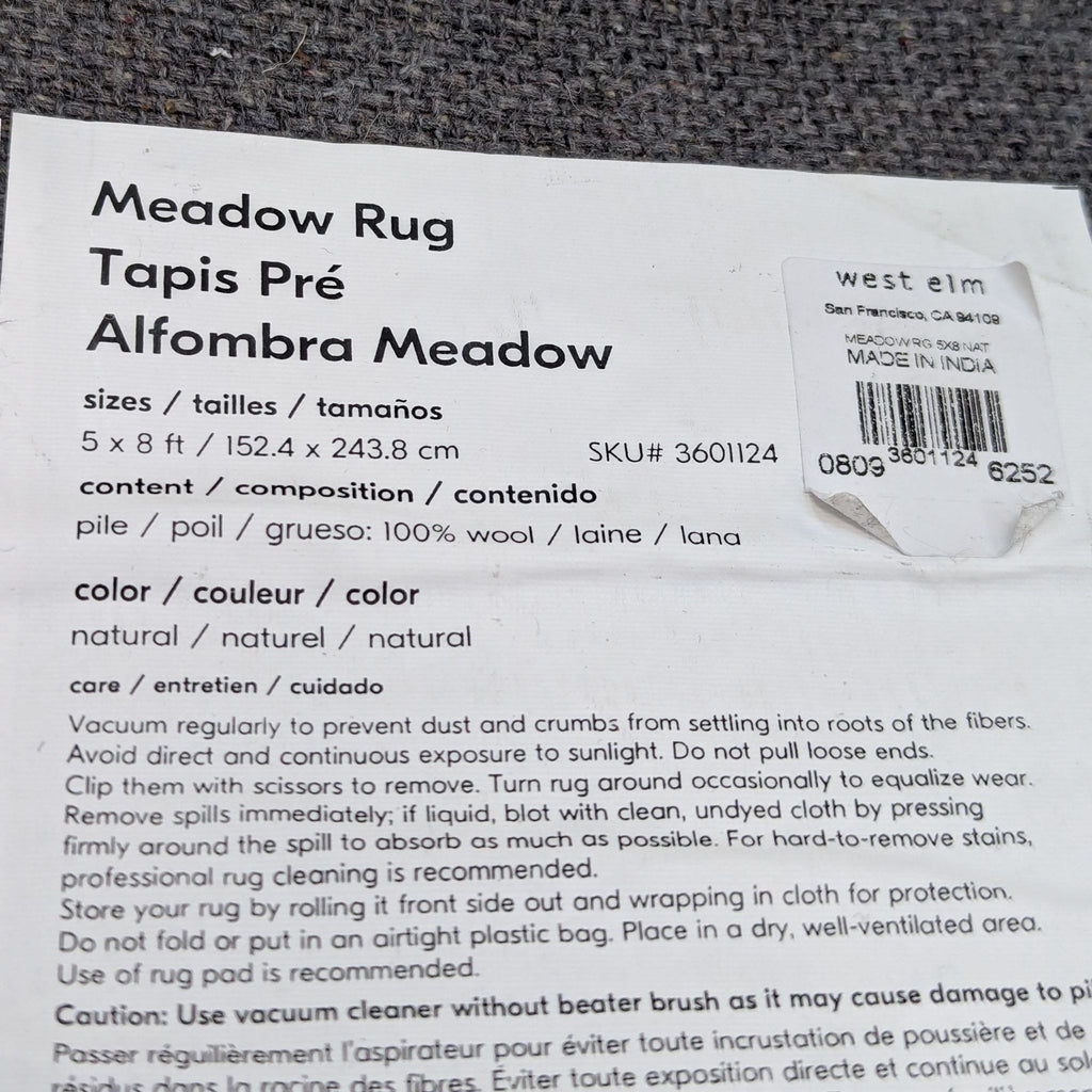 Label of the Meadow Area Rug by West Elm, detailing size, material, and care instructions.
