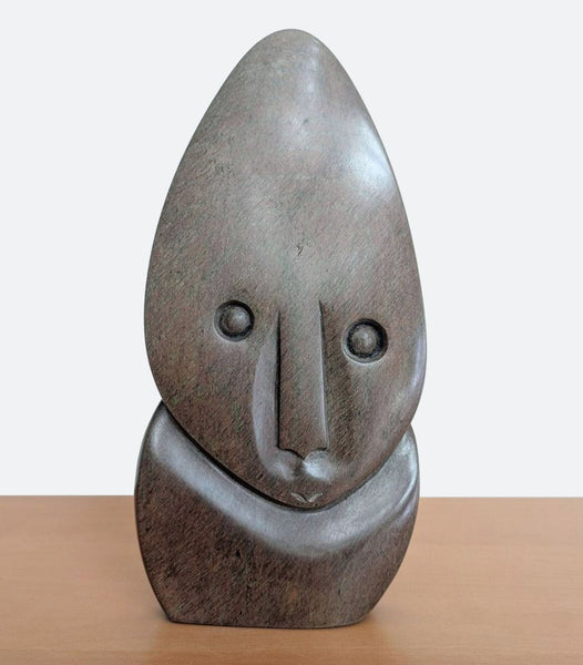 "Wide Eyed Child" by Zachariah Njobo, a gneiss sculpture depicting a child listening in wonder.