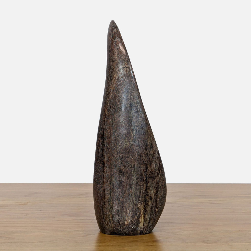 Side view of the Mutare Serpentine sculpture showcasing its smooth, tapered shape.