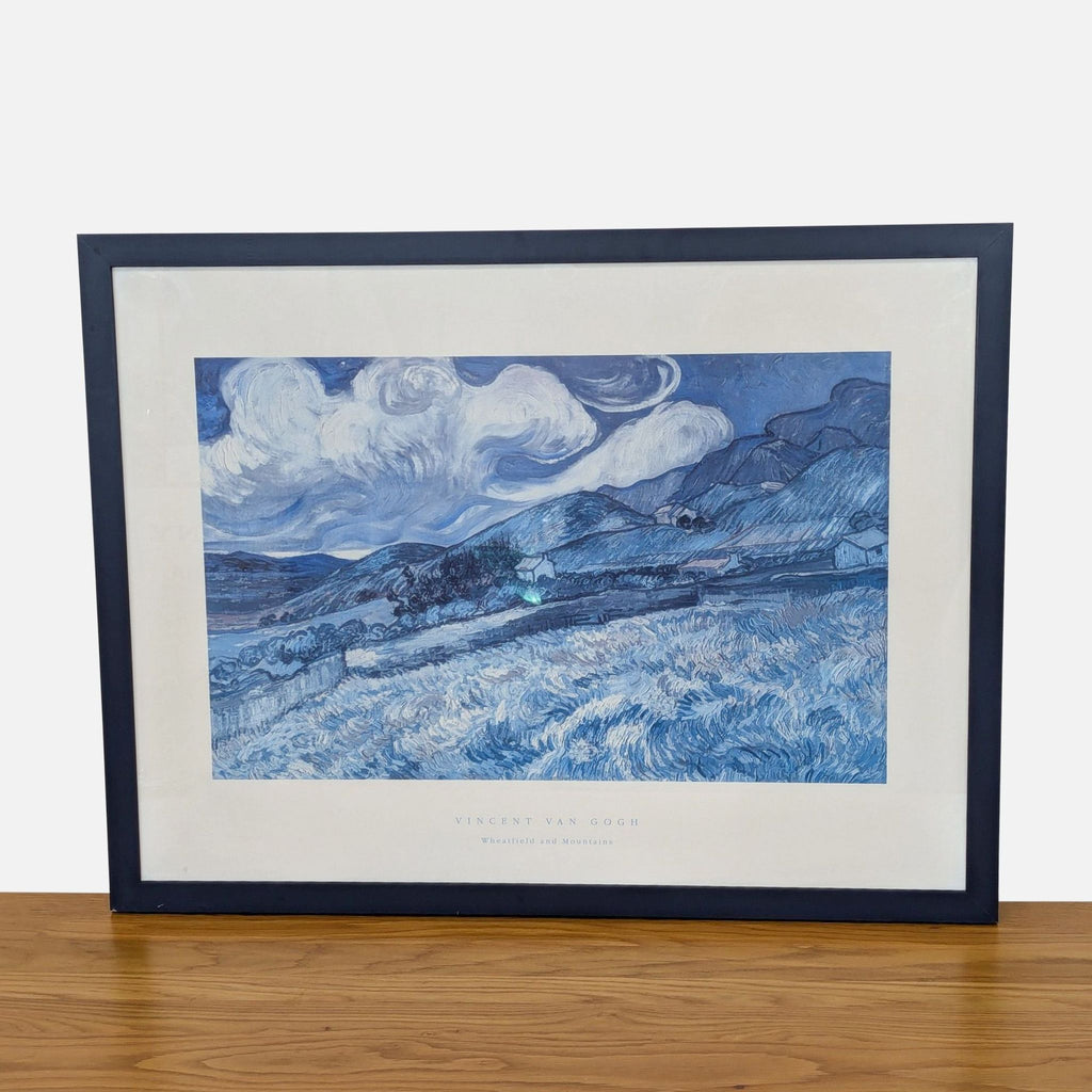 Framed Van Gogh print of "Wheatfield and Mountains," showcasing vivid blue landscapes.  