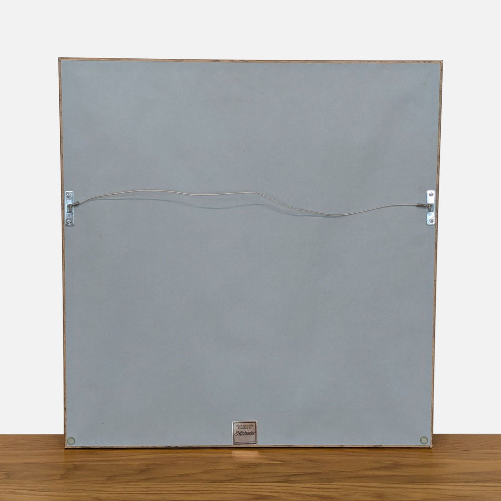 3. Back of a framed Reperch print, featuring hanging wire and label, suitable for wall display.