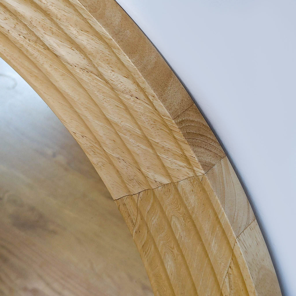Close-up of textured wooden frame detailing of mirror.