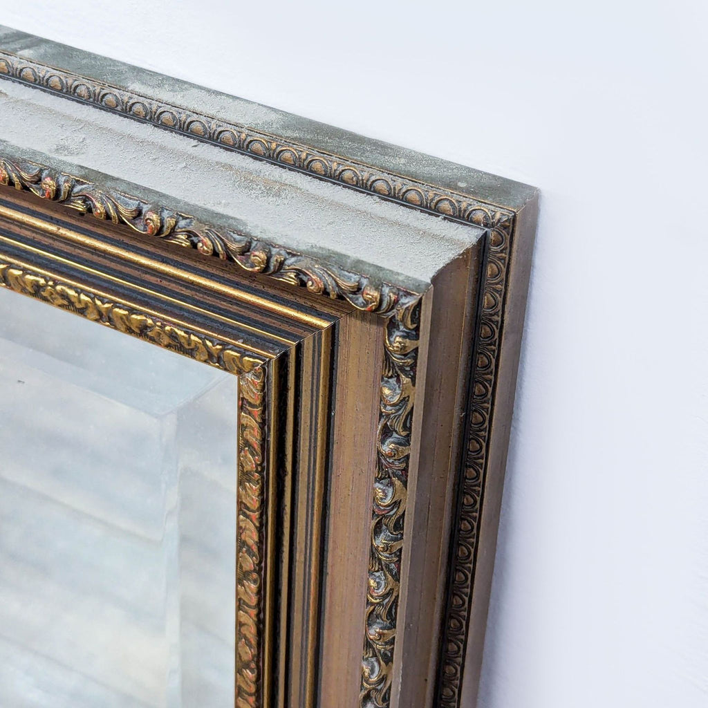 Close-up of ornate details on the Reperch mirror's gold-toned frame.