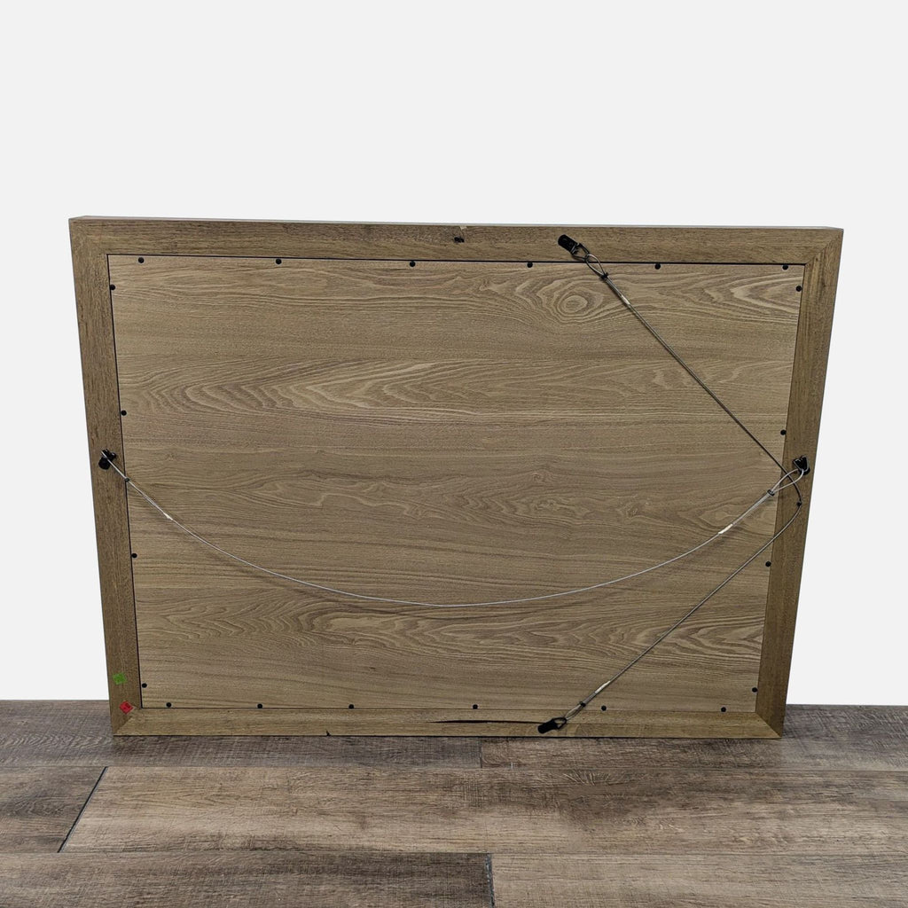 Back view of Reperch mirror shows hanging wire and wood grain details, set on wooden flooring.